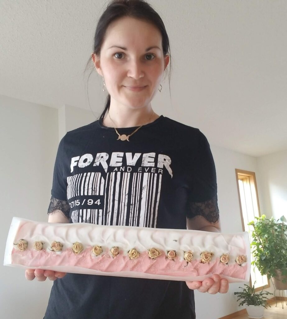 Casual Tania holding a giant brick of her natural soap production at home.