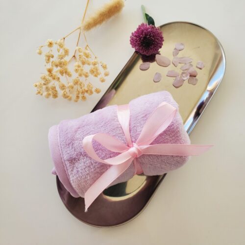 pink flannel makeup remover on stainless steel tray