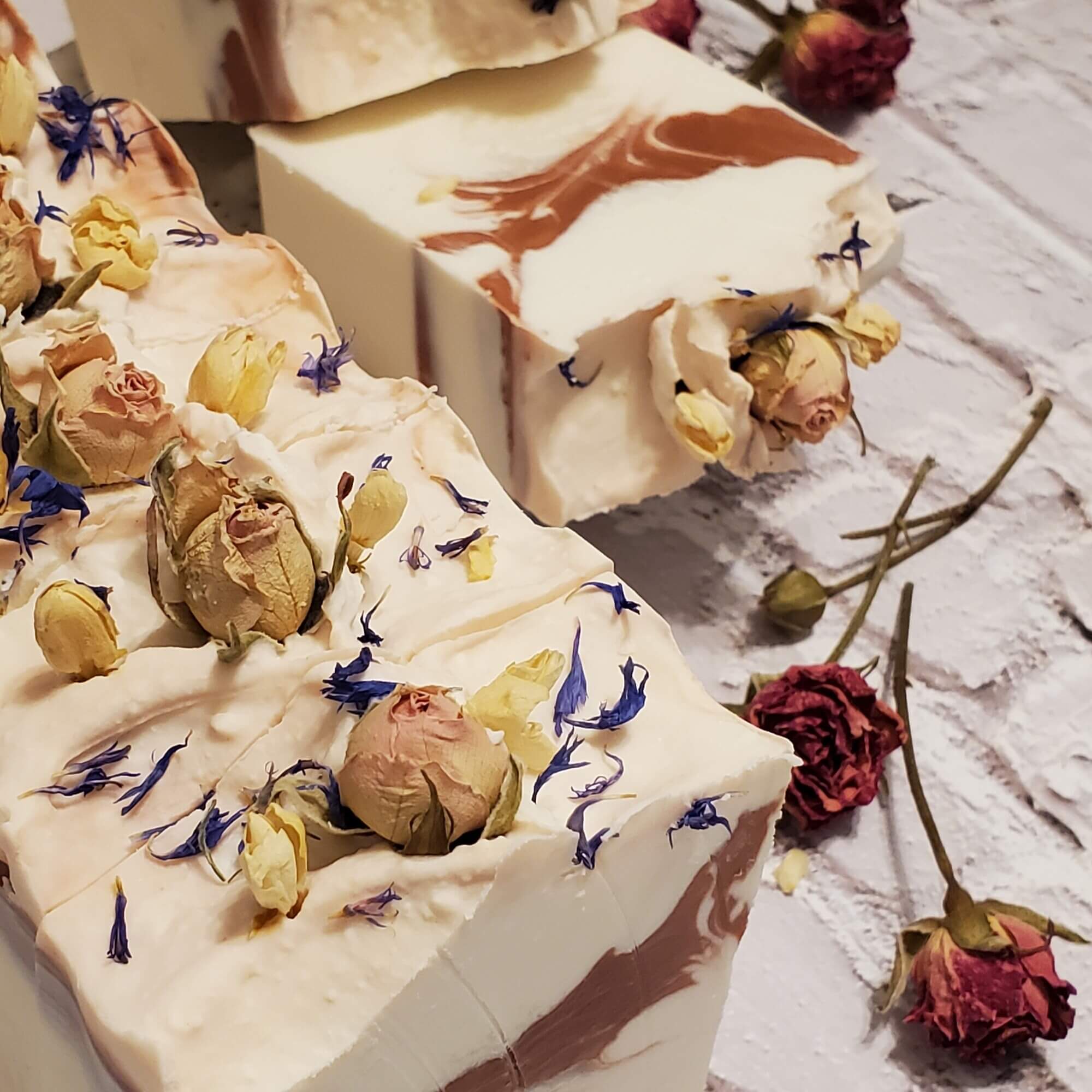 white and pink soap bars with rose buds